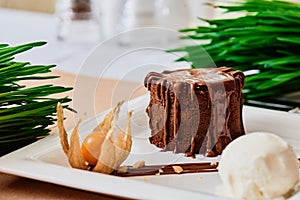 Beautiful dessert Chocolate Fondant with a scoop of cream ice cream on a white plate on the table in the restaurant