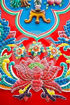 Beautiful detail of handmade Chinese style flower ceramic mosaic tile background in Chinese temple