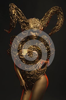 Beautiful devil women with golden ornamental horns photo