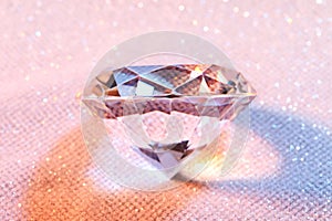 Beautiful diamond on shiny pink background, above view