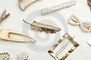 Beautiful different hair clips on white table