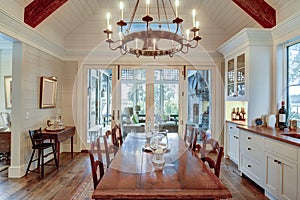 Beautiful diningroom with view onto porch and waterfront property photo
