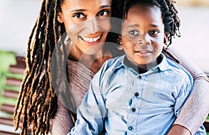 Beautiful diversity alternative family of black african people - mother and son smile in a portrait - trendy dreadlocks dredd hair