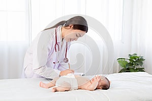 Beautiful doctor hand using stethoscope examining adorable infant heart, asian newborn baby get sick sleep during examine by