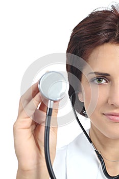 Beautiful doctor woman holding a stethoscope ready to auscultate photo