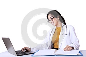 Beautiful doctor working with laptop