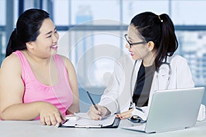 Beautiful doctor writes prescription to her patient