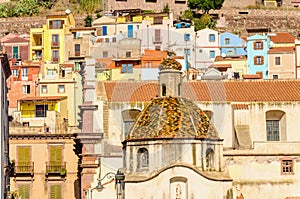 Beautiful dome on background of colorful buildings of Bosa, Sardinia, Italy