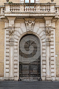 The beautiful door of San Callisto Palace in Trastevere district, Rome, Italy