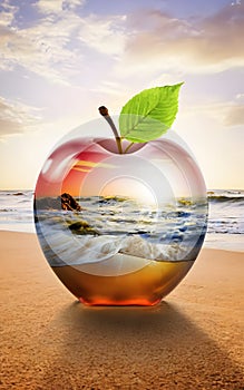 Beautiful double exposure image that combines a beach at sunrise and a glass apple.
