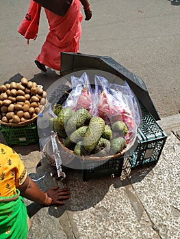 Beautiful Dragon Fruit, Kiwi and Guyabano or soursop fruit selling on wooden basket on roadside