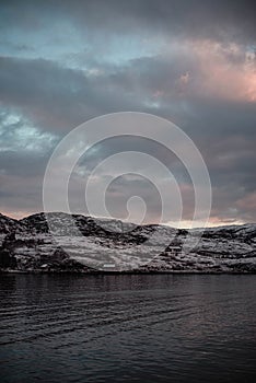 Beautiful dramatic colourful sunset above norwegian fjord in winter.