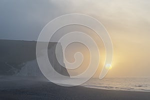 Beautiful dramatic foggy Winter sunrise Seven Sisters cliffs lan