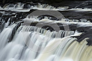 Beautiful dramatic landscape image of Aysgarth Falls in Yorkshire Dales in England during Winter morning