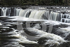 Beautiful dramatic landscape image of Aysgarth Falls in Yorkshire Dales in England during Winter morning