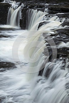 Beautiful dramatic landscape image of Aysgarth Falls in Yorkshire Dales in England during Winter morning