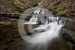Beautiful dramatic landscape image of Scaleber Force waterfall in Yorkshire Dales in England during Winter morning