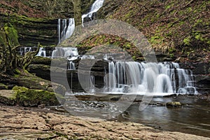 Beautiful dramatic landscape image of Scaleber Force waterfall in Yorkshire Dales in England during Winter morning