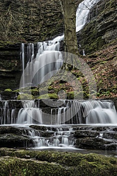 Beautiful dramatic landscape image of Scaleber Force waterfall in Yorkshire Dales in England during Winter morning