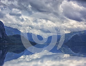 Beautiful and dramatic Norway landscape with mountains and sea in fjord