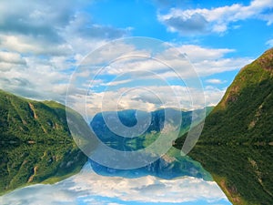 Beautiful and dramatic Norway landscape with mountains and sea in fjord