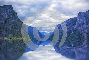 Beautiful and dramatic Norway landscape with mountains and sea in fjord