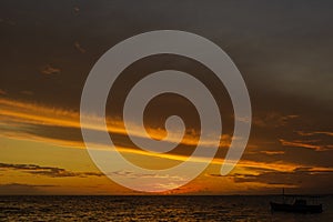 Beautiful dramatic orange sunset on a beach