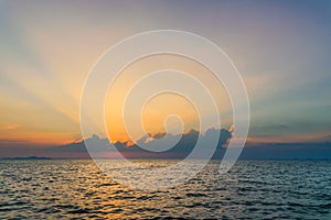 Beautiful dramatic sky clouds with light rays over the sea at sunset time. Natural landscape for background