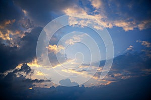 Beautiful dramatic sky with dark clouds at sunset, natural abstract background and texture