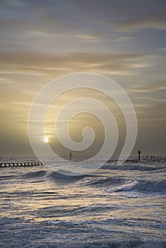 Beautiful dramatic stormy landscape image of waves crashing onto