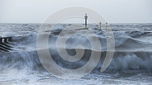 Beautiful dramatic stormy landscape image of waves crashing onto