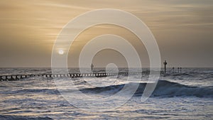 Beautiful dramatic stormy landscape image of waves crashing onto