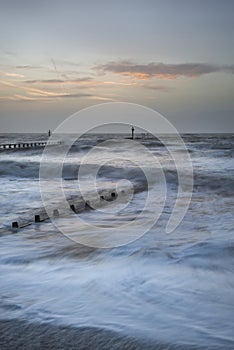 Beautiful dramatic stormy landscape image of waves crashing onto