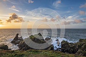 Beautiful dramatic Summer dawn over Lizard Point in Cornwall UK with lovely glowing sky and clouds