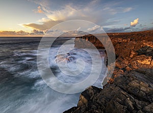 Beautiful and dramatic sunset on a craggy rocky cliff, Jandia Peninsula, Fuertaventura