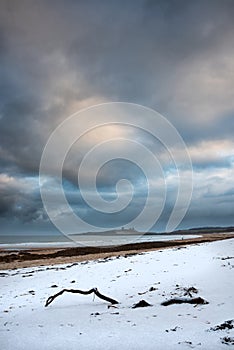 Beautiful dramatic unusual Winter landscape of snow on Embleton Bay beach in Northumberland England