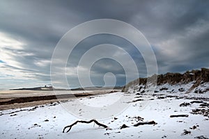 Beautiful dramatic unusual Winter landscape of snow on Embleton Bay beach in Northumberland England