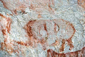 Beautiful drawings of ancient people in red ocher on the walls of a limestone cave