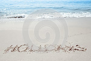 beautiful drawings inscription on the sand of the sea in the summer on the nature