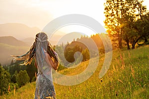 Beautiful dreadlock woman in mountains