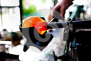 Beautiful drop of liquid glass, first step of glass blowing