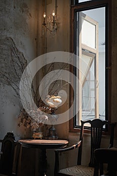 Beautiful dry flower pots interior on the antique wooden table decoration with light and shadow by the window retro for restaurant