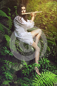 Beautiful dryad playing a flute