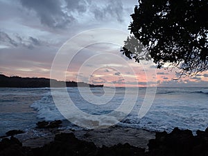 Beautiful Dusk light over the ocean with waves moving to shore