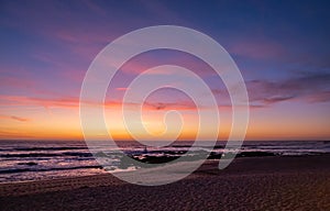 Beautiful dusk over beach in summer with vivid blue orange gradient sky and reflections photo