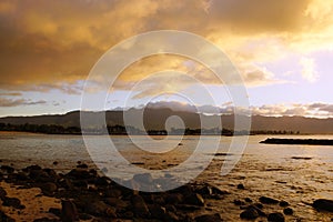 Beautiful Dusk over the ocean with waves moving to rocky shore a