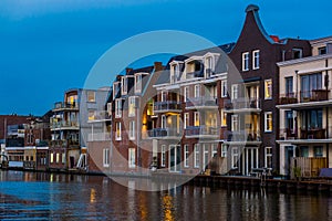 Beautiful dutch city architecture by night, luxurious houses with balconies, Alphen aan den Rijn, The Netherlands