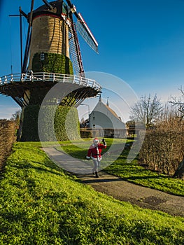 Beautiful Dutch mill and modern Santa Claus on the foreground