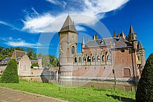 Beautiful dutch romantic fairy tale castle with towers, green garden park, blue summer sky - Kasteel Heeswijk, Netherlands