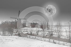 Beautiful Dutch winter windmill landscape with full moon black and white